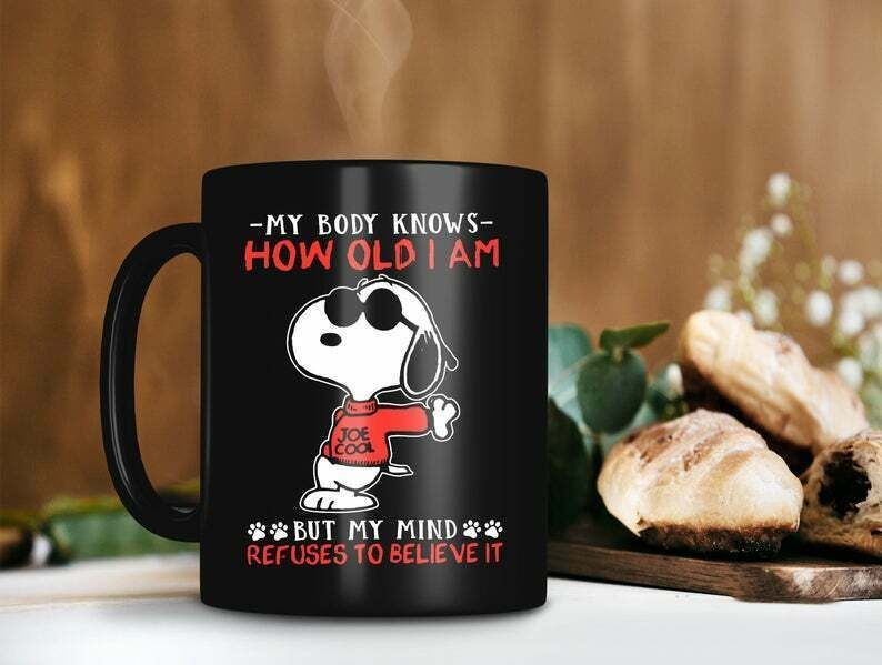 My Body Knows How Old I Am Mug But My Mind Refuses To Believe It Snoopy Peanuts Premium Sublime Ceramic Coffee Mug Black